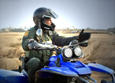 Border Patrol Officer On Atv Desert