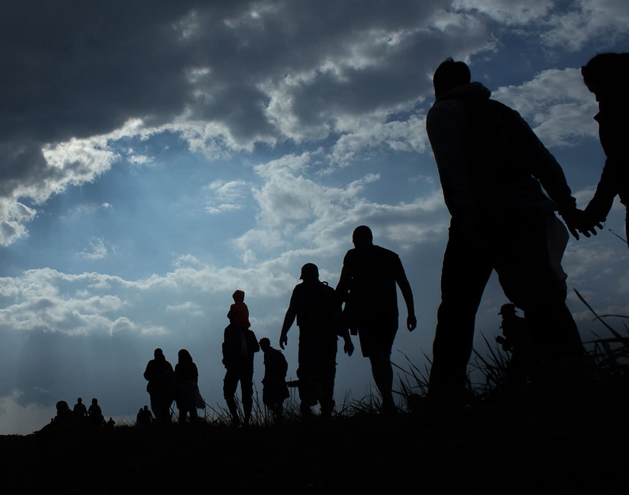 Migrants Walking Dark Clouds2